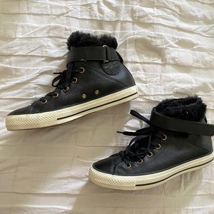 Converse vintage high top leather sneakers.